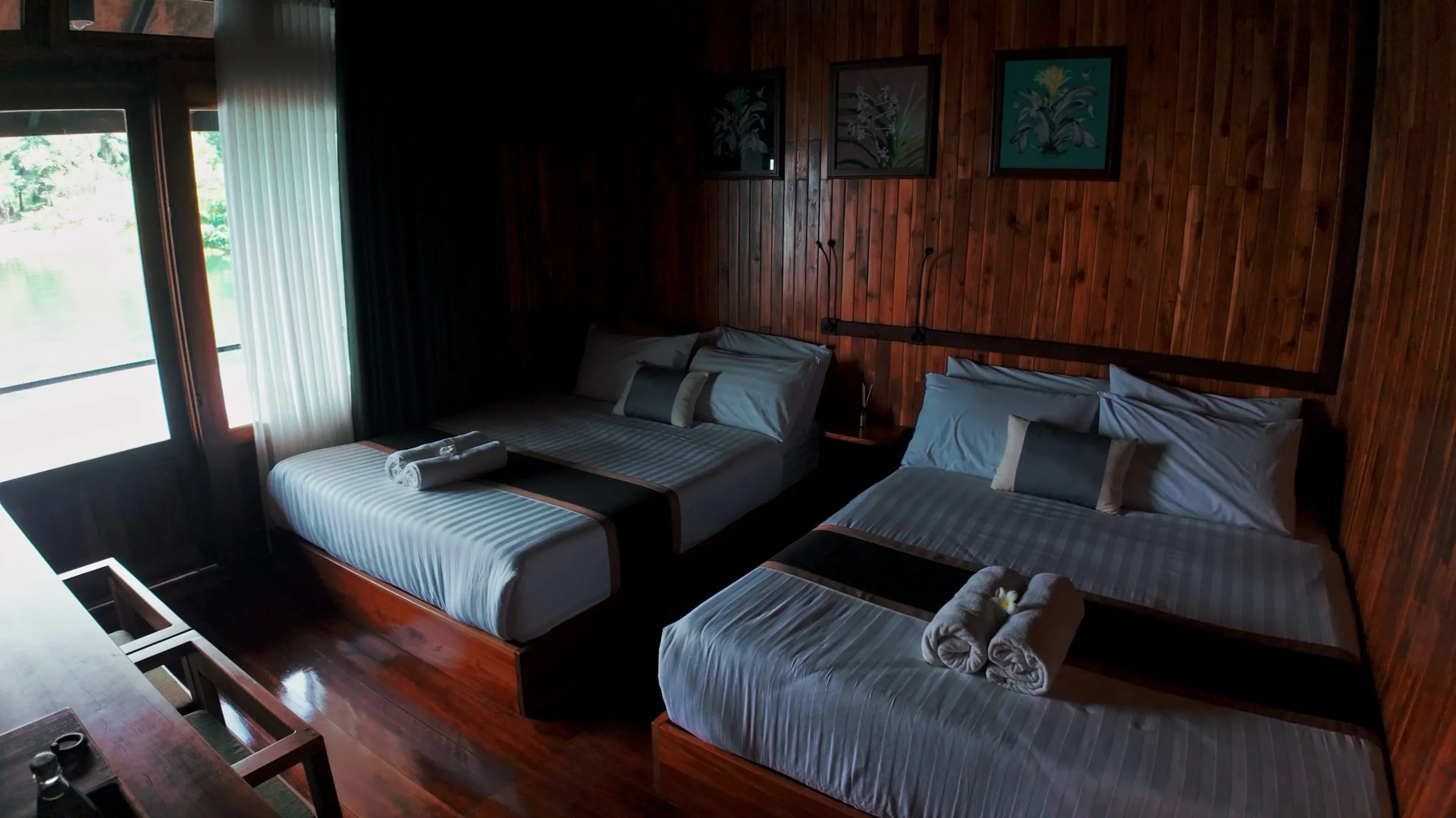 A private bedroom with twin beds and a sofa inside the floating house.
