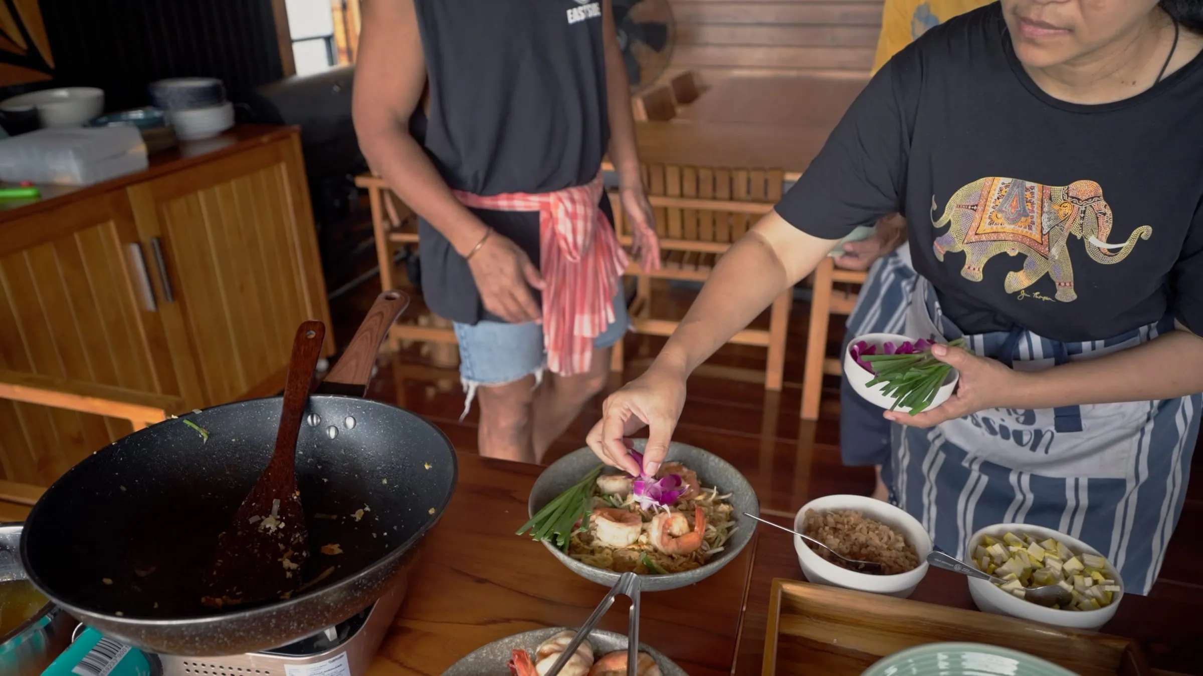 A Thai cooking demonstration laid out on the deck of the floating house.